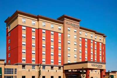 a large building with a red and tan at Four Points by Sheraton Edmonton Gateway in Edmonton