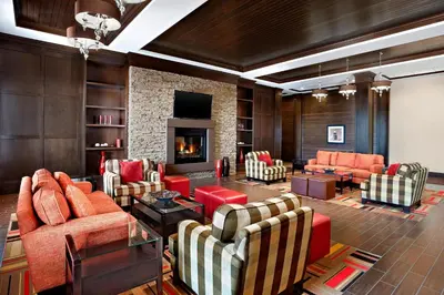 a living room with couches and a fireplace at Four Points by Sheraton Edmonton Gateway in Edmonton