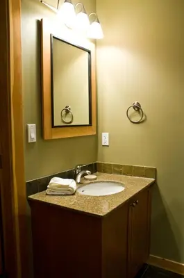a bathroom with a sink and a mirror at Pinnacle Ridge Chalets by Fernie Lodging Co in Fernie