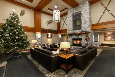 a living room with a christmas tree and a fireplace at The Aspens by Whistler Premier in Whistler