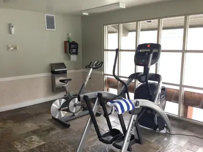 a gym with two exercise bikes in a room at The Aspens by Whistler Premier in Whistler