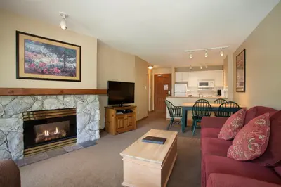 a living room with a couch and a fireplace at The Aspens by Whistler Premier in Whistler
