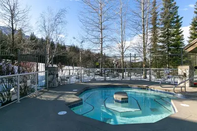 a swimming pool in a yard with a fence at The Aspens by Whistler Premier in Whistler