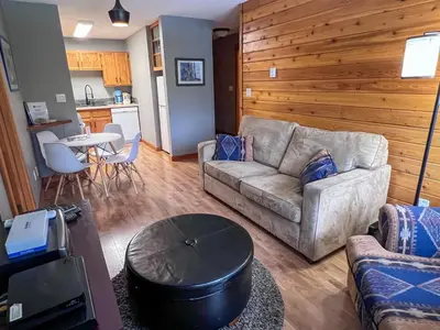 a living room with a couch and a table at Griz Inn by Fernie Central Reservations - Right on The Slopes in Fernie