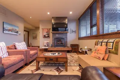 a living room with a couch and a fireplace at Luxurious 901 Condos by Fernie Central Reservations in Fernie