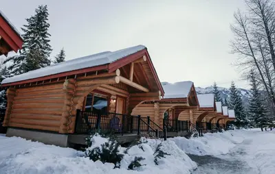 a log cabin in the snow at Riverside Resort in Whistler