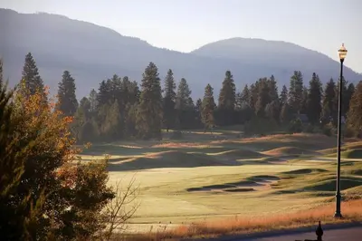 a man is standing on a golf course at A Vacation Paradise at Quail Ridge B&B in Kelowna