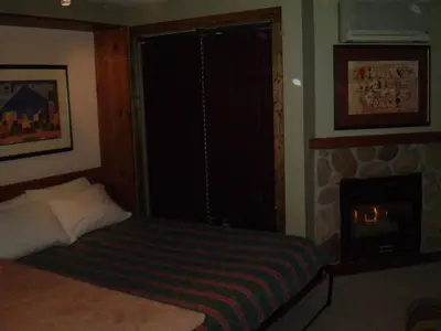a bedroom with a bed and a fireplace at Studio suite located in the heart of Whistler village in Whistler