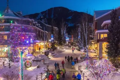 a group of people walking around a town with christmas lights at Studio suite located in the heart of Whistler village in Whistler
