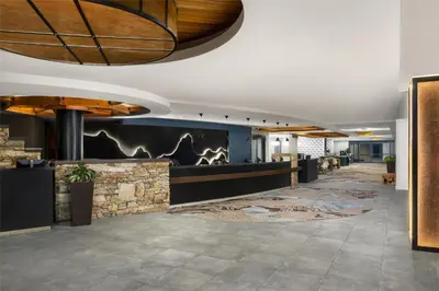 a lobby of a hotel with a stone wall at Hilton Whistler Resort & Spa in Whistler