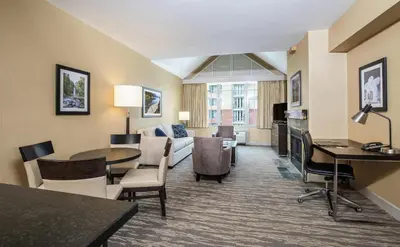 a living room with a couch and a table at Hilton Whistler Resort & Spa in Whistler