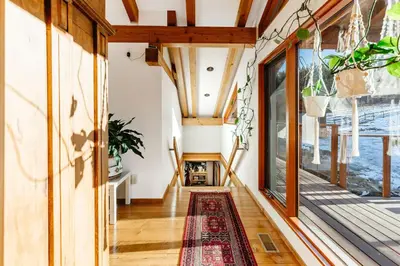 an open hallway with a rug on the floor and large windows at Myra Canyon Guest Ranch in Kelowna
