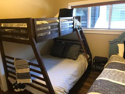 two bunk beds in a room with a bed at Port Renfrew Vacation Rentals in Port Renfrew