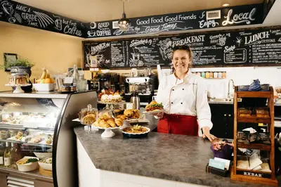 a woman standing behind a counter in a bakery at Summerland Waterfront Resort & Spa in Summerland