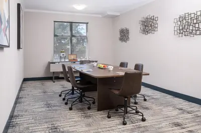 a conference room with a wooden table and chairs at Four Points by Sheraton Victoria Gateway in Victoria