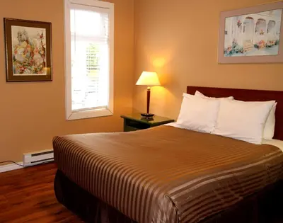 a bedroom with a large bed and a window at Hotel Squamish in Squamish