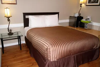 a bedroom with a large bed and a table at Hotel Squamish in Squamish