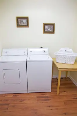 two washing machines and a table in a room at Hotel Squamish in Squamish