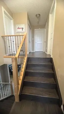 a hallway with a staircase in a house at Monthly Accommodation Edmonton Londondery, Pilot Sound, McConachie Area in Edmonton