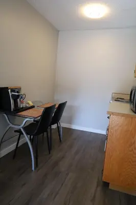 a room with a table and chairs in a room at Skylite Motel in Parksville