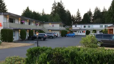 a parking lot in front of a motel at Skylite Motel in Parksville