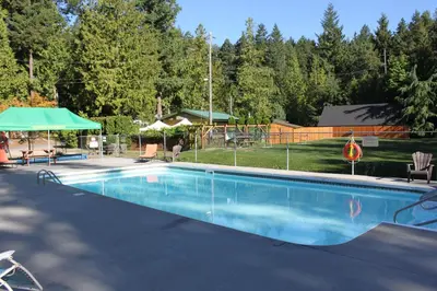 a swimming pool in a yard with at Pender Harbour Resort & Marina in Garden Bay