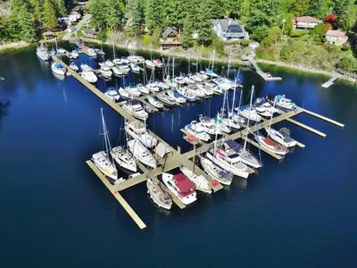a bunch of boats docked at a dock in the water at Pender Harbour Resort & Marina in Garden Bay