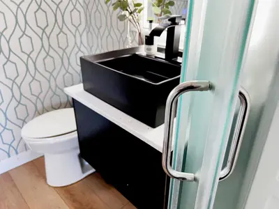 a bathroom with a black sink and a toilet at Oceanside Villas in Sechelt