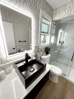 a bathroom with a black sink and a toilet at Oceanside Villas in Sechelt
