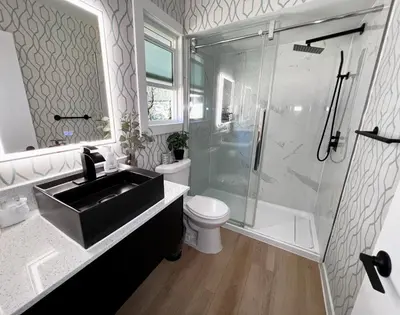 a bathroom with a sink and a shower and a toilet at Oceanside Villas in Sechelt