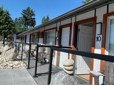 a side view of a building with a porch at Oceanside Villas in Sechelt