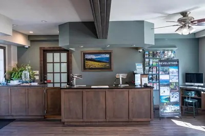 a store with a counter in a room with a ceiling at Swiss Chalet Motel in Revelstoke