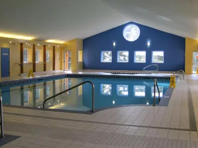 a large swimming pool with a blue wall at Manning Park Resort in Manning Park