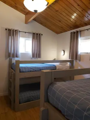 two bunk beds in a room with wooden ceilings at Manning Park Resort in Manning Park
