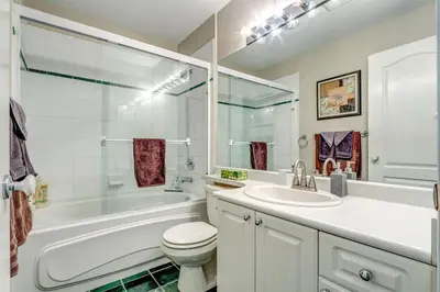 a bathroom with a tub and a toilet and a sink at Town Plaza Suites by Golden Dreams in Whistler
