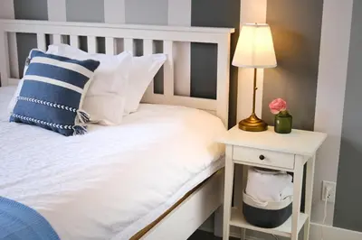 a bedroom with a white bed with a lamp and a side table at Vancouver West Cozy Retreat by Host Launch in Vancouver