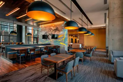 a restaurant with tables and chairs in a room at Residence Inn by Marriott Calgary Downtown/Beltline District in Calgary