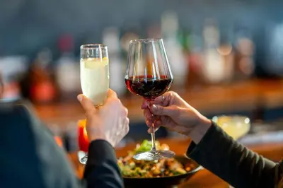 two people are holding up glasses of wine at Residence Inn by Marriott Calgary Downtown/Beltline District in Calgary