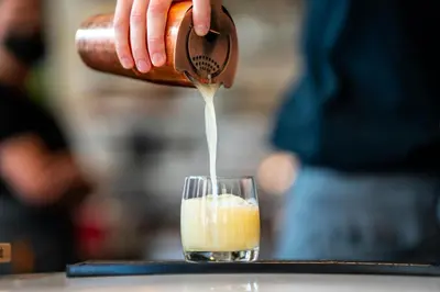 a person pouring a drink into a glass at Residence Inn by Marriott Calgary Downtown/Beltline District in Calgary