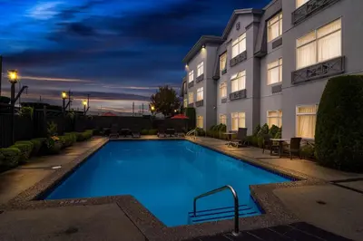 a pool in front of a hotel at night at Best Western Plus Pitt Meadows Inn & Suites in Pitt Meadows