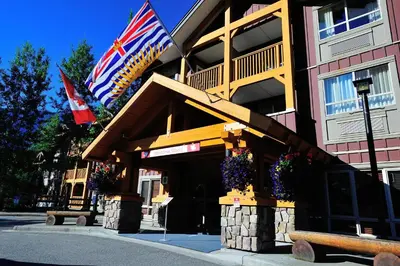 a building with flags on the side of it at Pemberton Valley Lodge in Pemberton