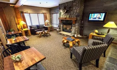 a living room with a fireplace and a television at Pemberton Valley Lodge in Pemberton