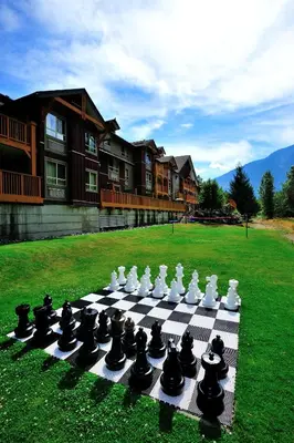 a chess board on a lawn in front of a house at Pemberton Valley Lodge in Pemberton