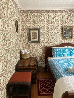 a bedroom with a bed and a table in it at St. George Hotel in Barkerville
