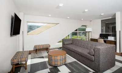 a living room with a couch and a table at Pomeroy Hotel Fort McMurray in Fort McMurray