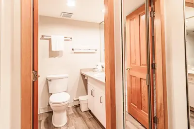 a bathroom with a toilet and a sink at Lake Placid Lodge by Elevate Vacations in Whistler