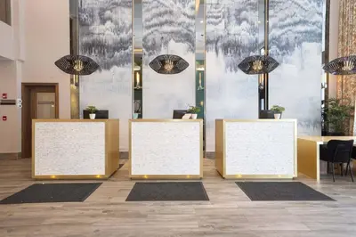 a lobby with a row of tables with whiteboards at Sandman Signature Sherwood Park Hotel in Sherwood Park