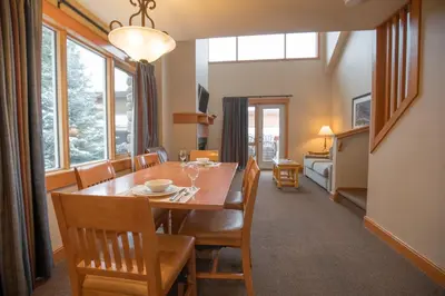 a dining room with a table and chairs at The Hidden Ridge Resort in Banff