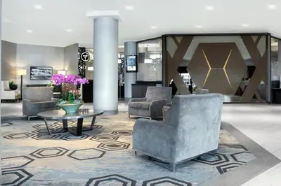 a lobby with couches and a table and flowers at Sheraton Vancouver Guildford Hotel in Surrey