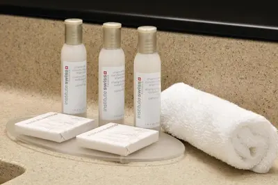 three bottles of toilet paper and a roll of paper towels at Travelodge by Wyndham Edmonton South in Edmonton